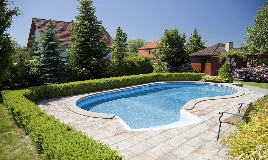 concrete inground pool and brick floor